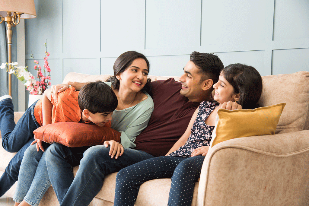 family sitting on couch at home | air conditioning systems phoenix az scottsdale az 