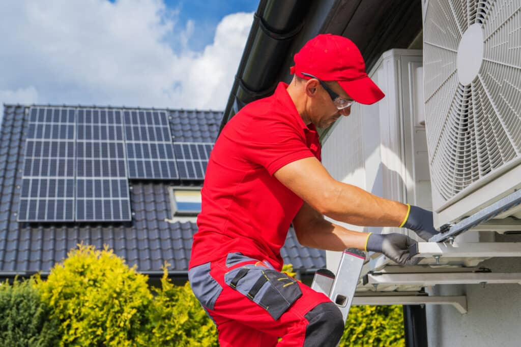 HVAC Worker Performing Heat Pump Maintenance. Device is Transferring Thermal Energy From the Outside Using the Refrigeration Cycle. Home Heating Technologies. AC Repair in Scottsdale