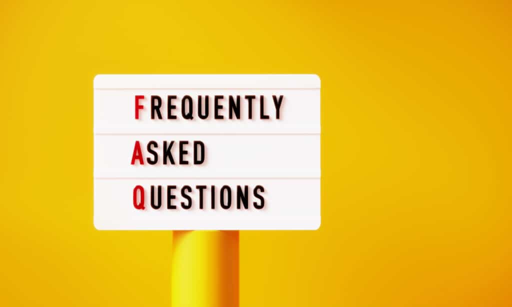 FAQ written white lightbox on yellow podium before yellow background. FAQs for AC Repair in Scottsdale